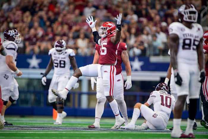 Sep 25, 2021; Arlington, Texas, USA; Arkansas Razorbacks defensive lineman Tre Williams (55) celebrates a sack of Texas A&M Aggies quarterback Zach Calzada (10) during the second quarter at AT&T Stadium. Mandatory Credit: Jerome Miron-USA TODAY Sports